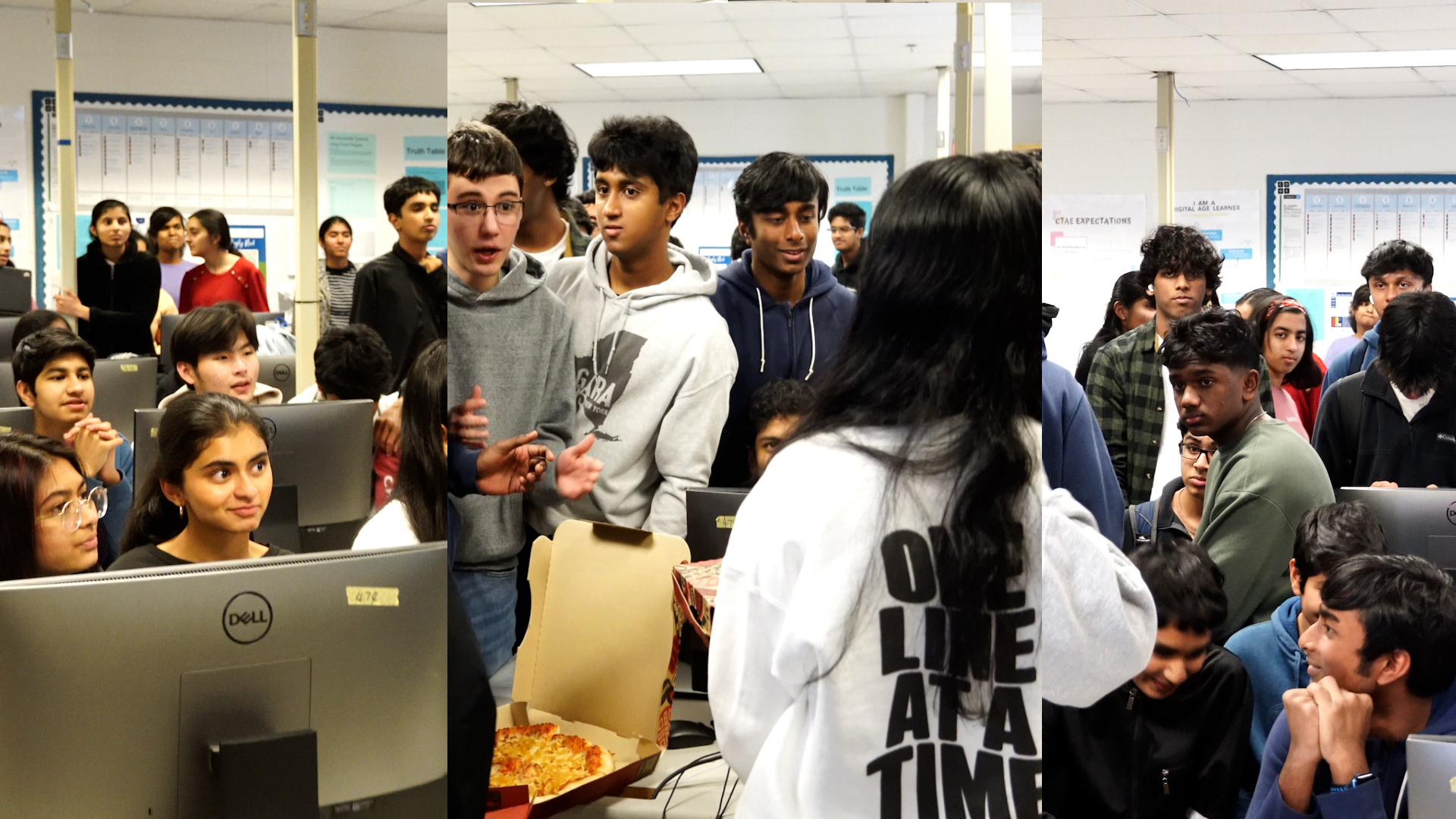 a group of engaged students gathers in a computer lab, focusing on a central figure in a white hoodie.